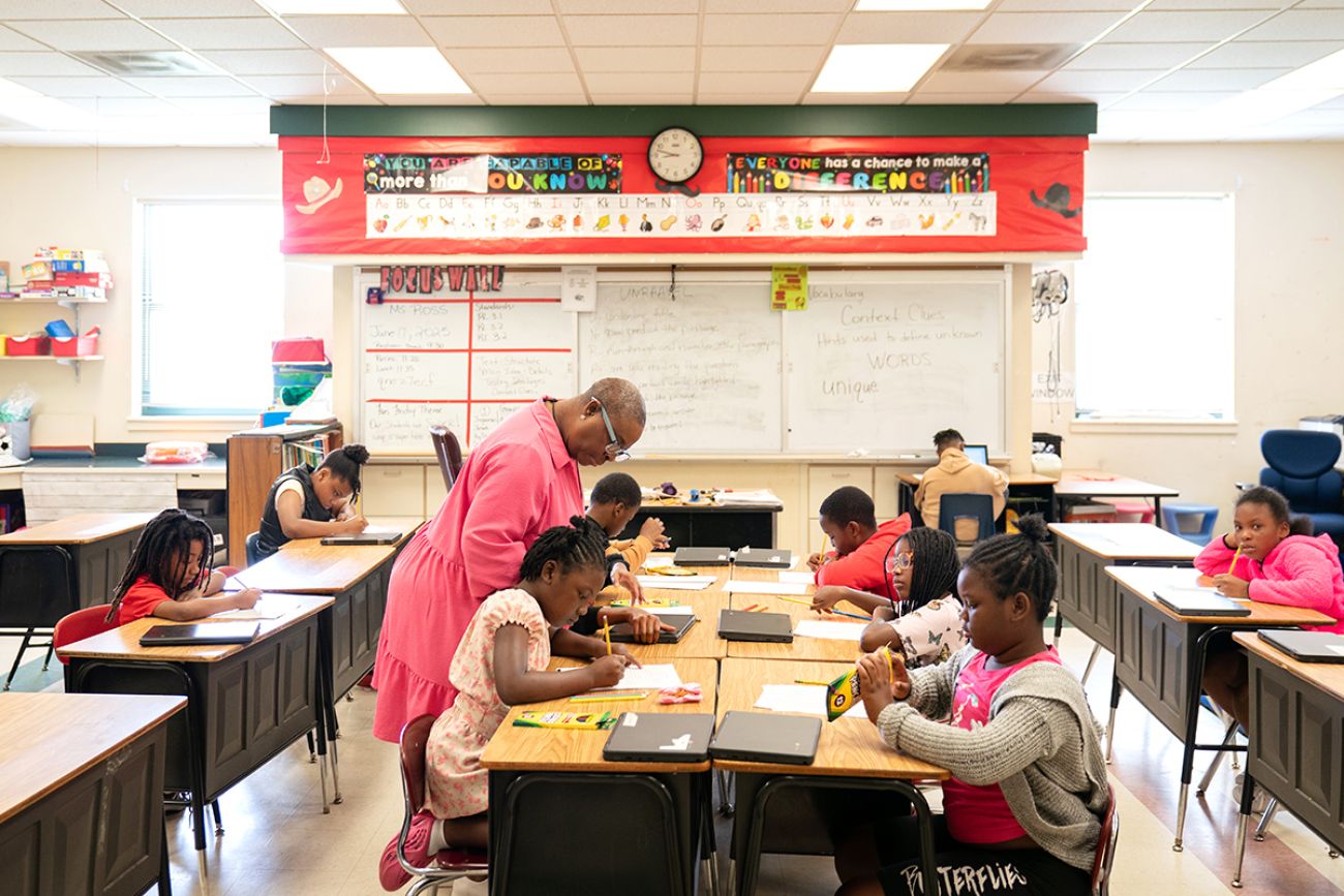 Teacher with her students in a classroom.