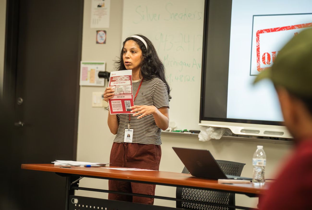Inas Ismail talks into a microphone.