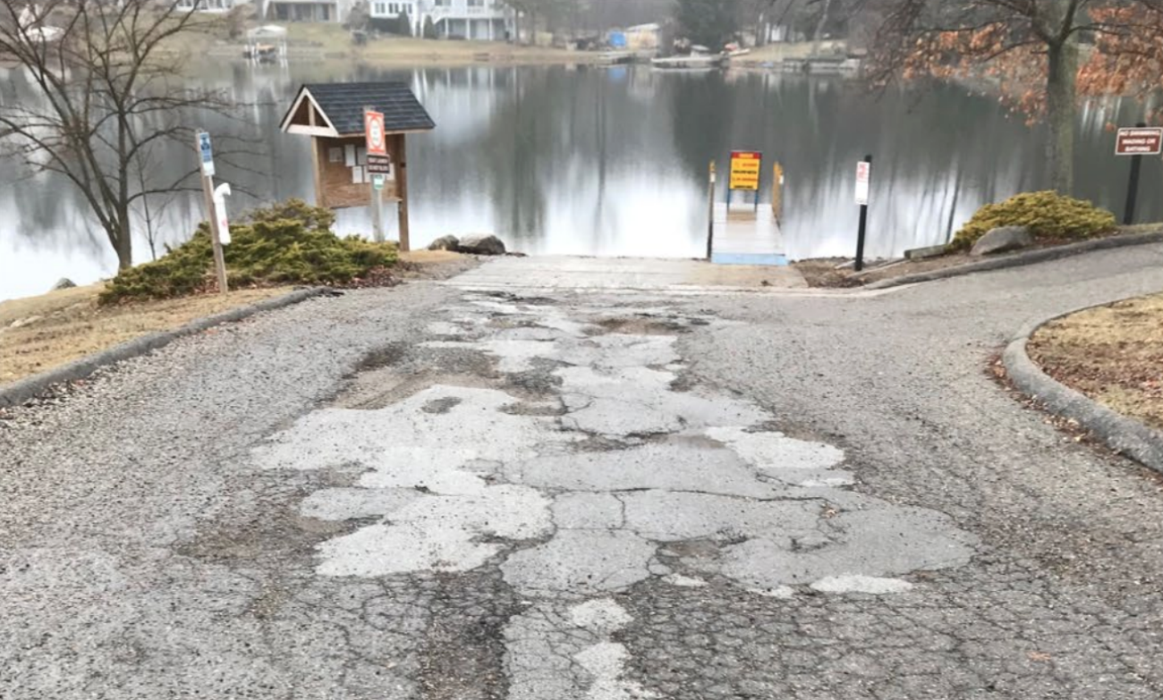 Man potholes on a boat ramp. 