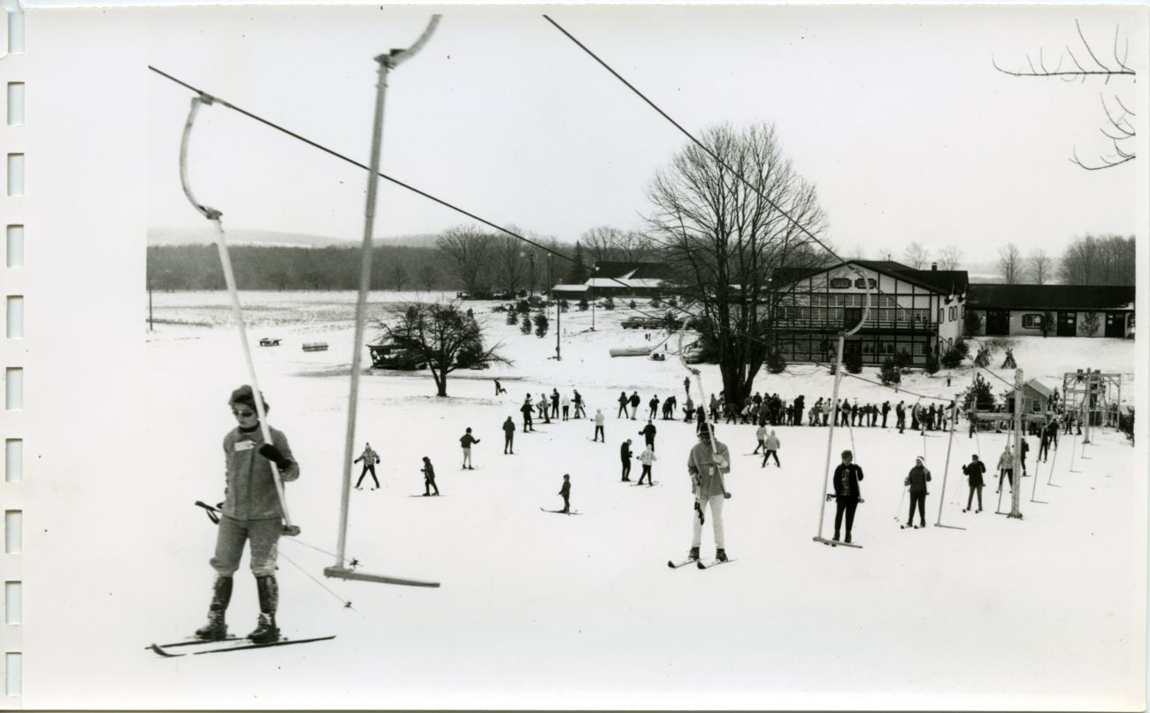 A black-and-white photo of skiers. 