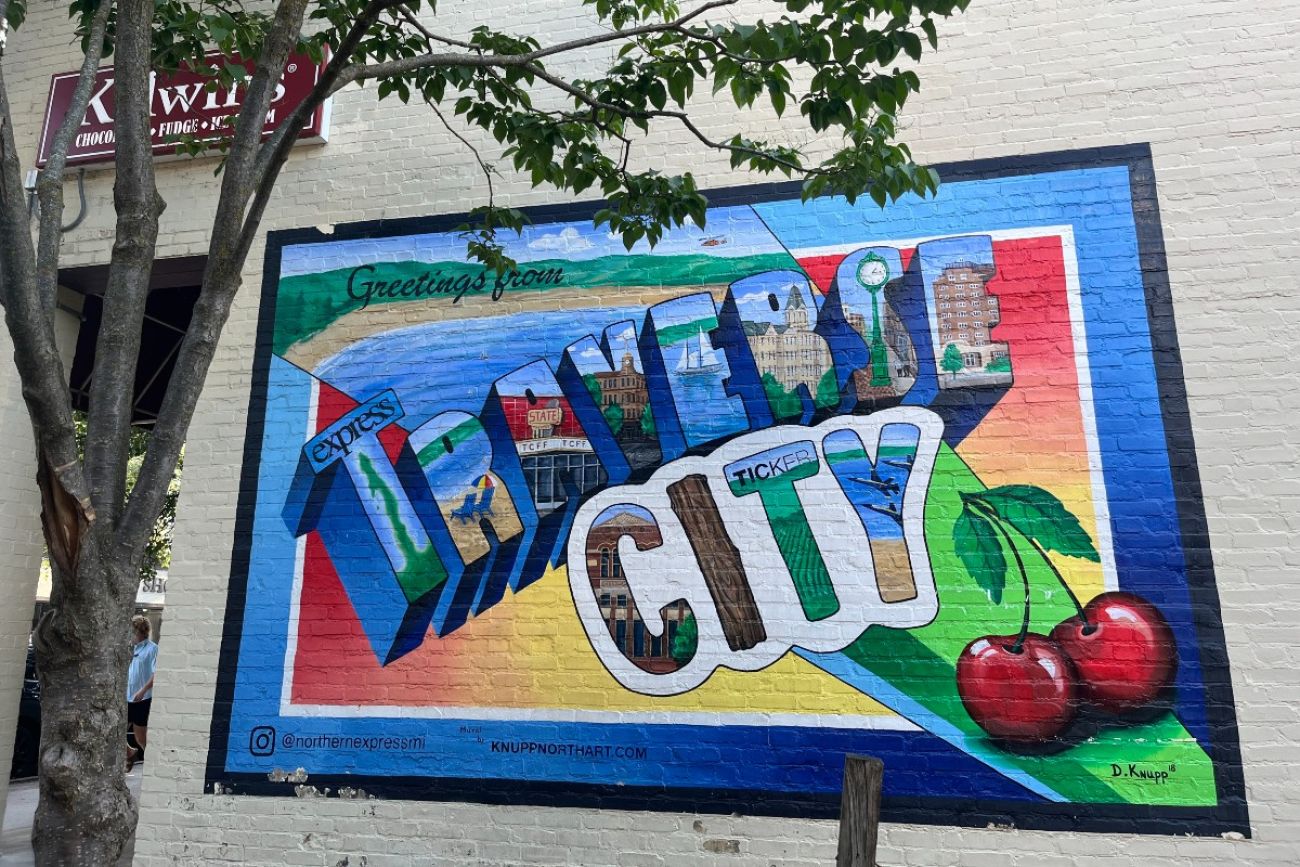 A mural painted on the exterior wall of a Traverse City business says "Traverse City" in colorful letters
