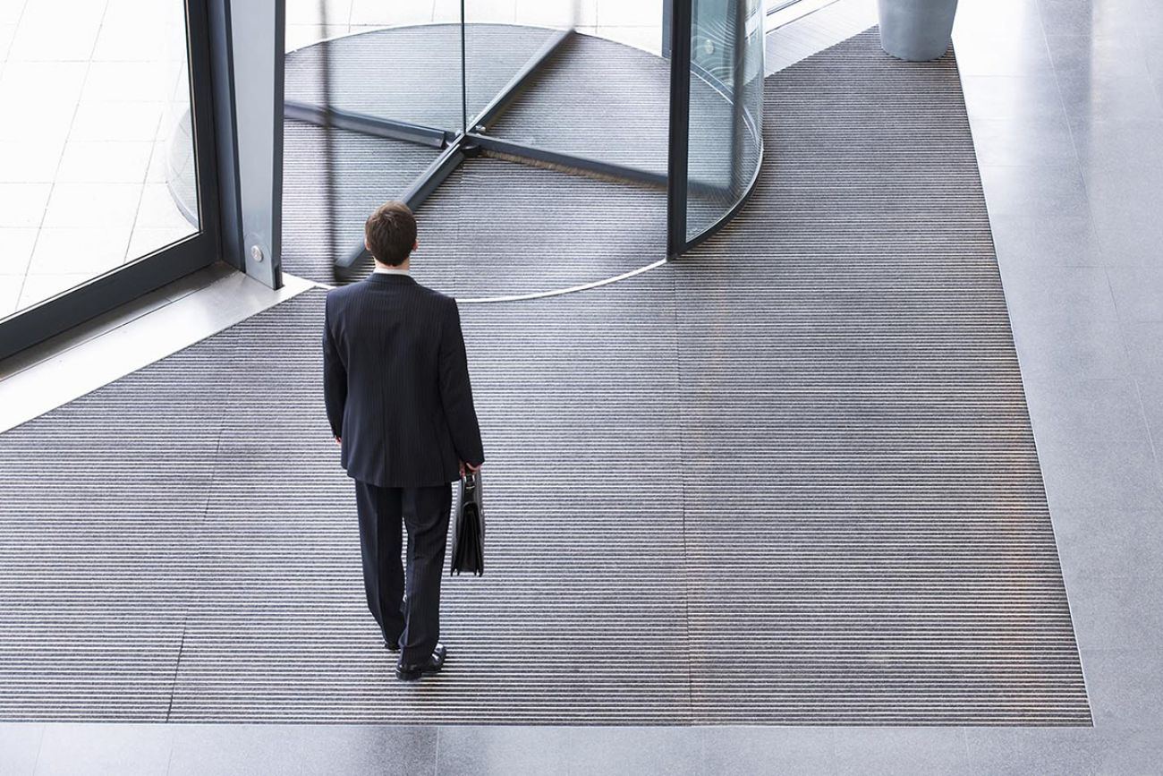 man standing in front of a revolving door