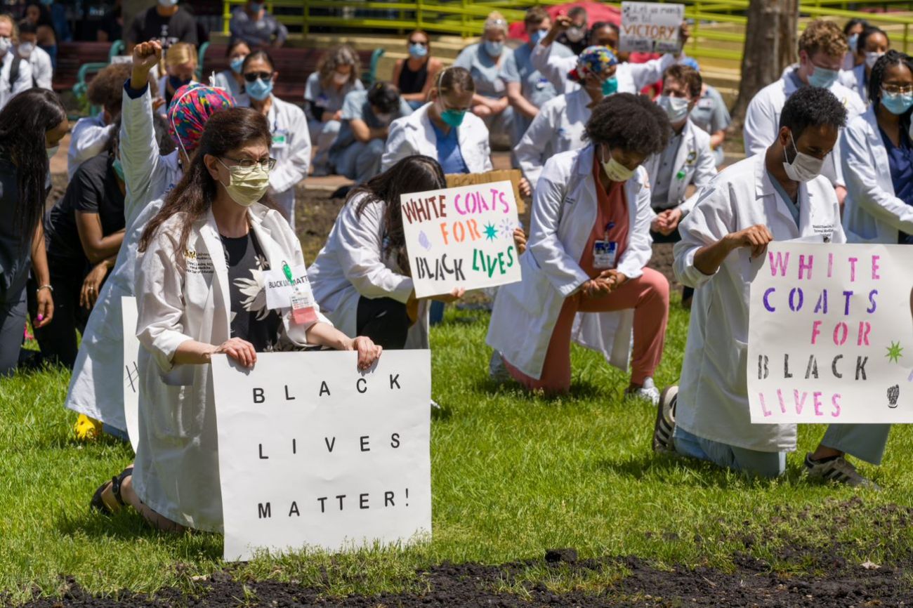 people in white coats kneeling