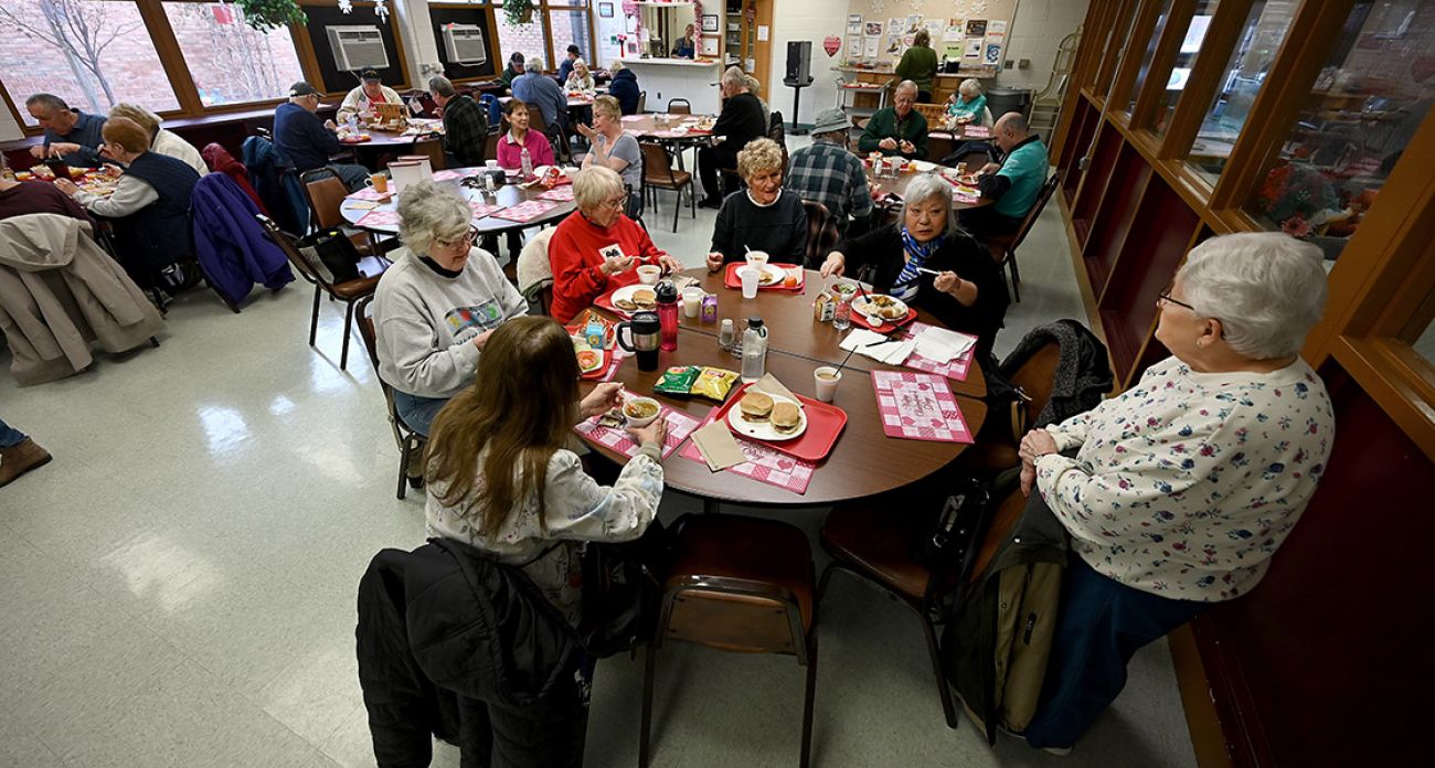 People sitting at tables at the senior center