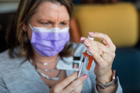 nurse holding vaccine