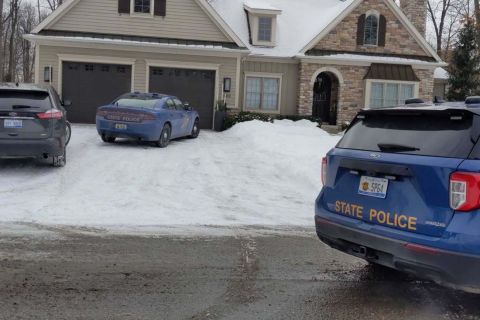 house with MSP police cars nearby