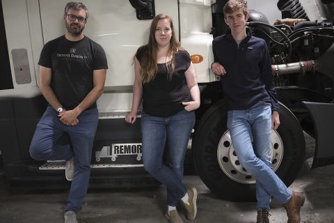 three people in front of the truck