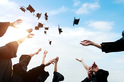 graduation hats being thrown up to air