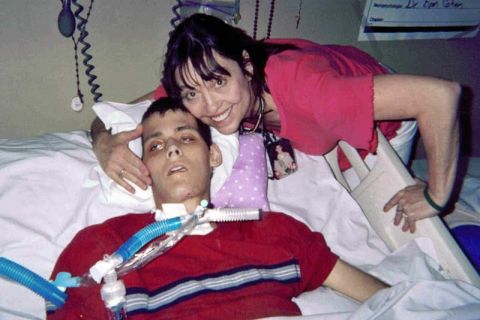woman next to son on hospital bed