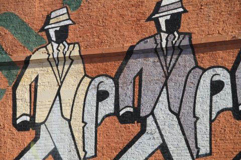 mural of two men walking 