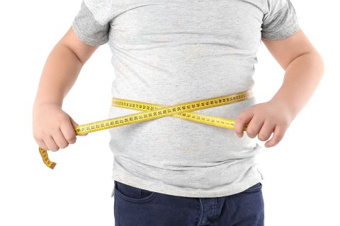child measuring waist