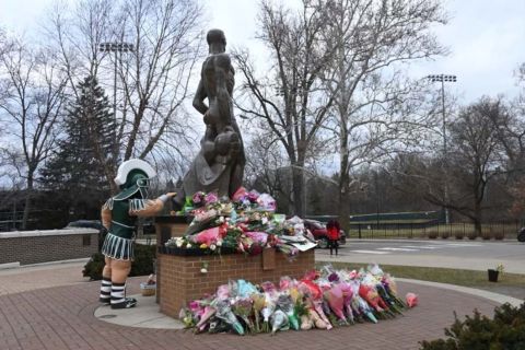 Sparty touches the Spartan Statue
