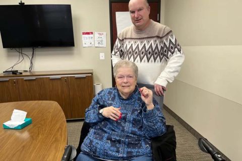 woman in wheelchair and a man standing behind her