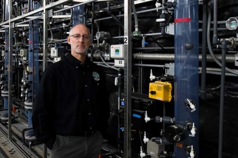 Brian Steglitz standing in front of pipes