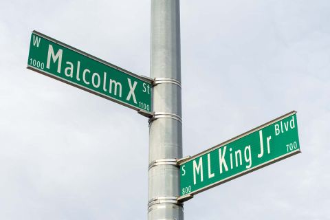 Street signs for Martin Luther King Jr and Malcolm X. Civil rights leaders in Lansing Michigan