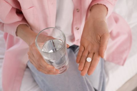 woman taking pill