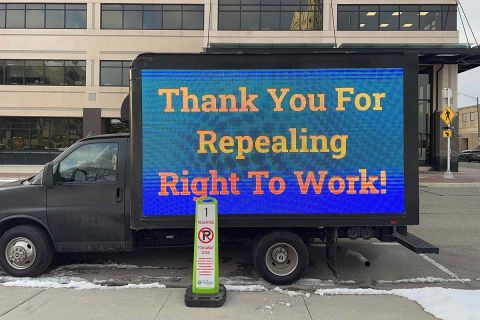 mobile billboard truck with a sign that says "Thank You for Repealing Right-to-Work