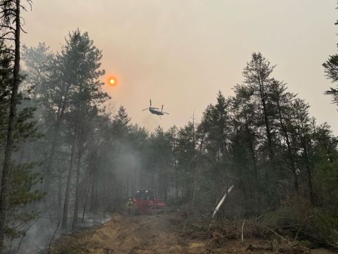 Aircraft flying over forrest fire in Michigan