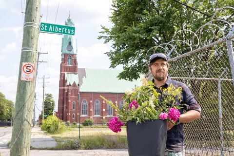 Tim Nutt holding a pot of flowers