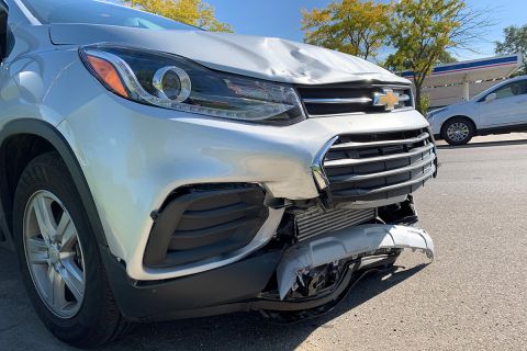 busted fender on a grey suv