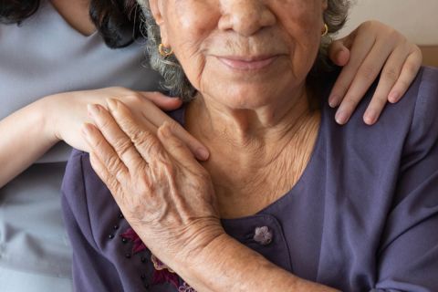 Woman comforts elderly woman