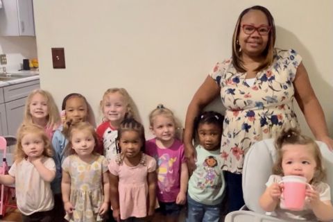 Kim Spivey standing next to children