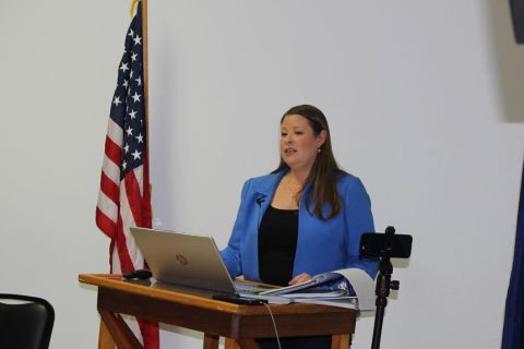 Stefanie Lambert speaking at a podium
