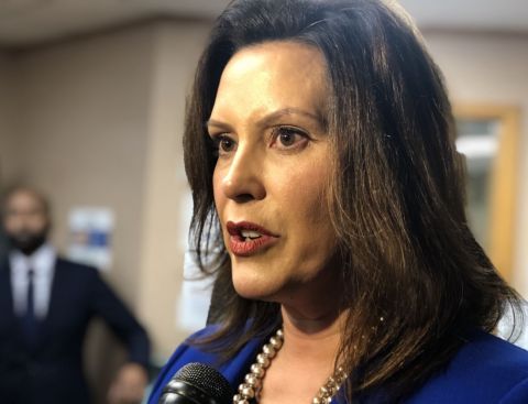 Michigan Gov. Gretchen Whitmer with a microphone in front of her