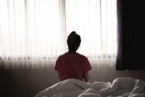 woman sitting alone in a bed