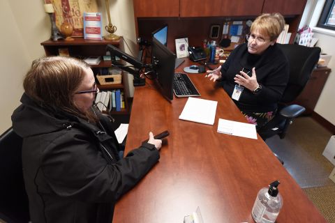 two people talking to each other across a table