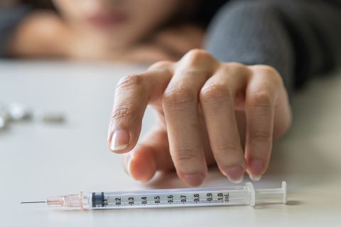 girl hand reaching for syringe,