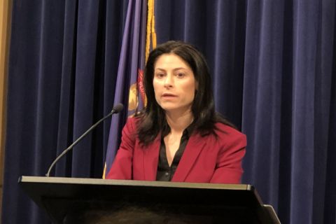 Dana Nessel stands at a podium