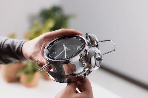 Male hand adjusting or changing the time on clock.