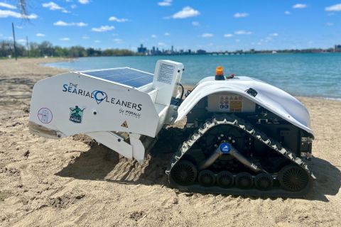 a small white robot on the beach