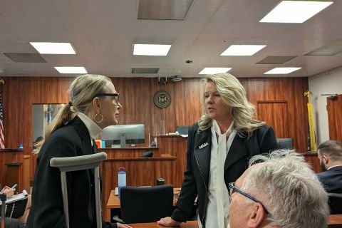 two women standing in a courtroom