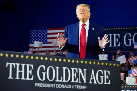 Donald Trump waves to a crowd at Macomb Community College during a rally