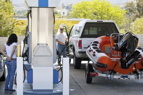 Two people in a gas station. 