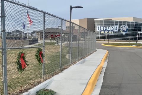 Outside view of Oxford High School. A memorial is on the side. 