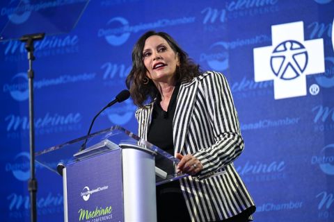 Gretchen Whitmer stands at podium