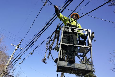 A worker working on a power line. 