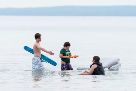 Kids swim in a lake