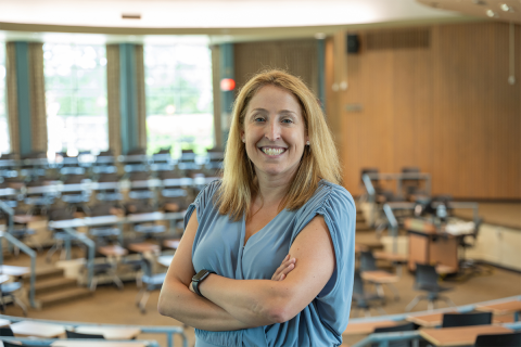 Kelley Cusmano poses for a photo in a classroom.