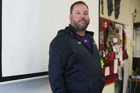 Corey Rosser poses for a photo in his classroom.