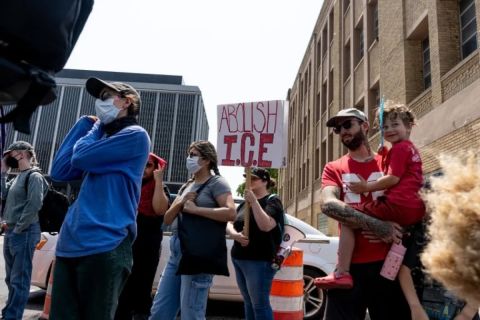 People holding 'ABOLISH ICE' sign