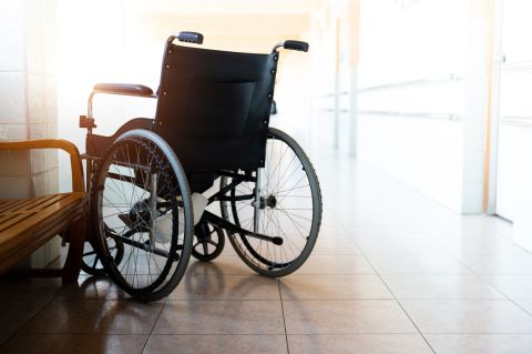 Wheelchair parked in hospital hallway.