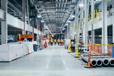 People walking in an auto plant.