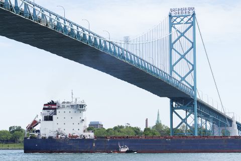 A freighter goes underneath the Ambassador Bridge.