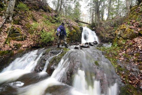 Steve Jurmu hiking a waterfall.