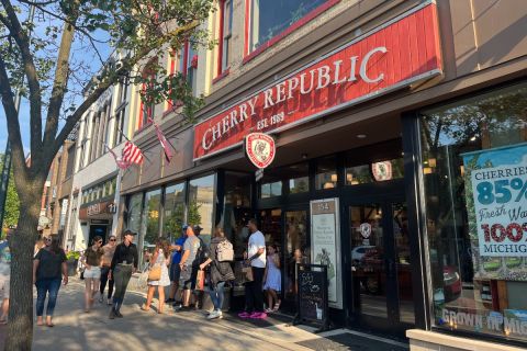 Shoppers stream out of a Cherry Republic store in downtown Traverse City