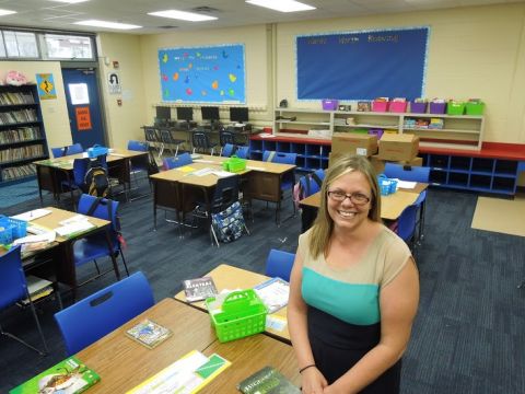 Leslie Moore sitting in her fourth-grade classroom